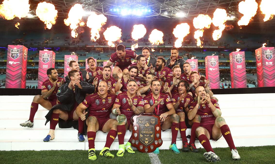 Champions: The Maroons celebrate with the State Of Origin trophy after winning the series 2-1 against New South Wales Blues at ANZ Stadium. Picture: Getty Images