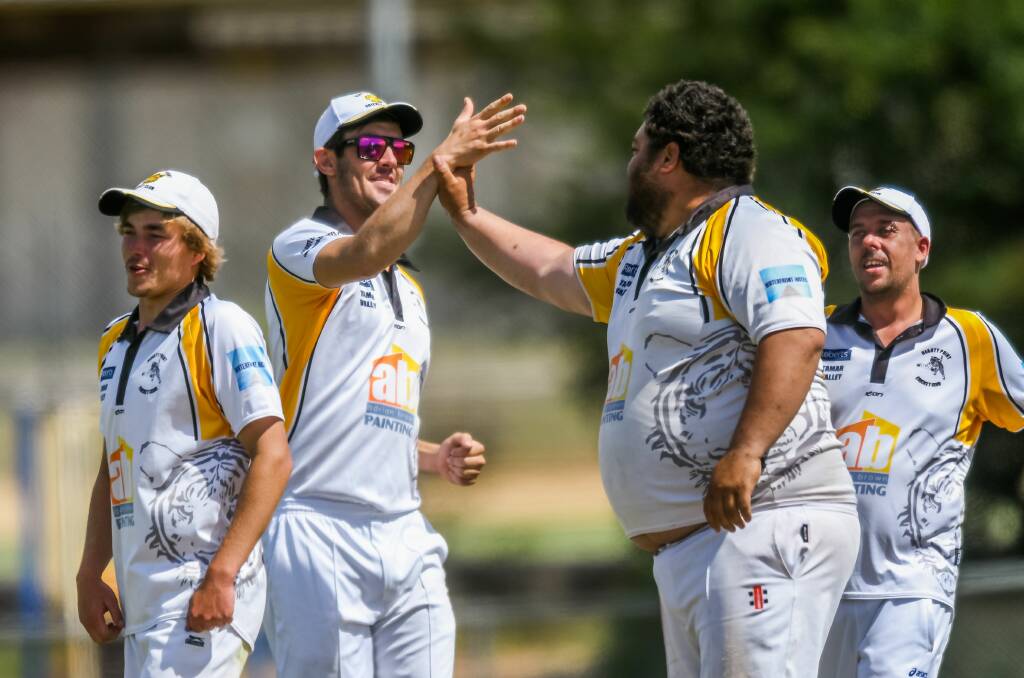 COME ON: Quinton Tahiri celebrates one of his six wickets with his teammates. Picture: Phillip Biggs