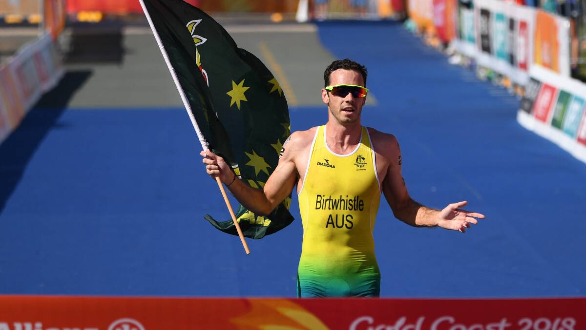 WINNER: Jake Birtwhistle crosses the finish line after winning the mixed team relay triathlon final on day three of the XXI Commonwealth Games at Southport Broadwater Parklands. Picture: AAP