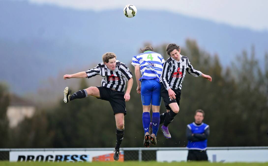 FLYING HIGH: Launceston City's Shane Egan and Kyle Clifford jump for the ball either side of Somerset's Dyson Buckingham. Pictures: Phillip Biggs.