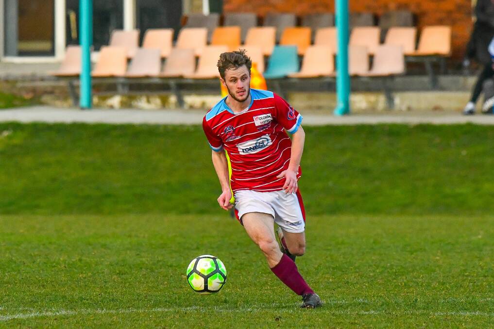 COMPOSED: Northern Rangers Pat Lanau-Atkinson looks to push the ball forward in the NPL Tasmania clash with Clarence United on Saturday. Picture: Scott Gelston