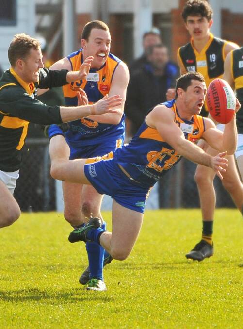 ON BOARD: Scott Stephens gets a handball away playing for Evandale last season. The former Launceston premiership player will assist Eagles coach Anthony Axton in 2017.
