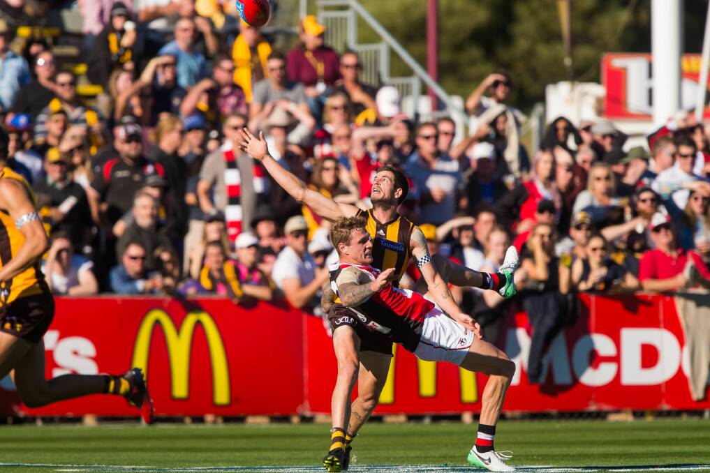FACE LIFT: Hawthorn's Ben Stratton and St Kilda's Tim Membrey clash at UTAS Stadium earlier this year.