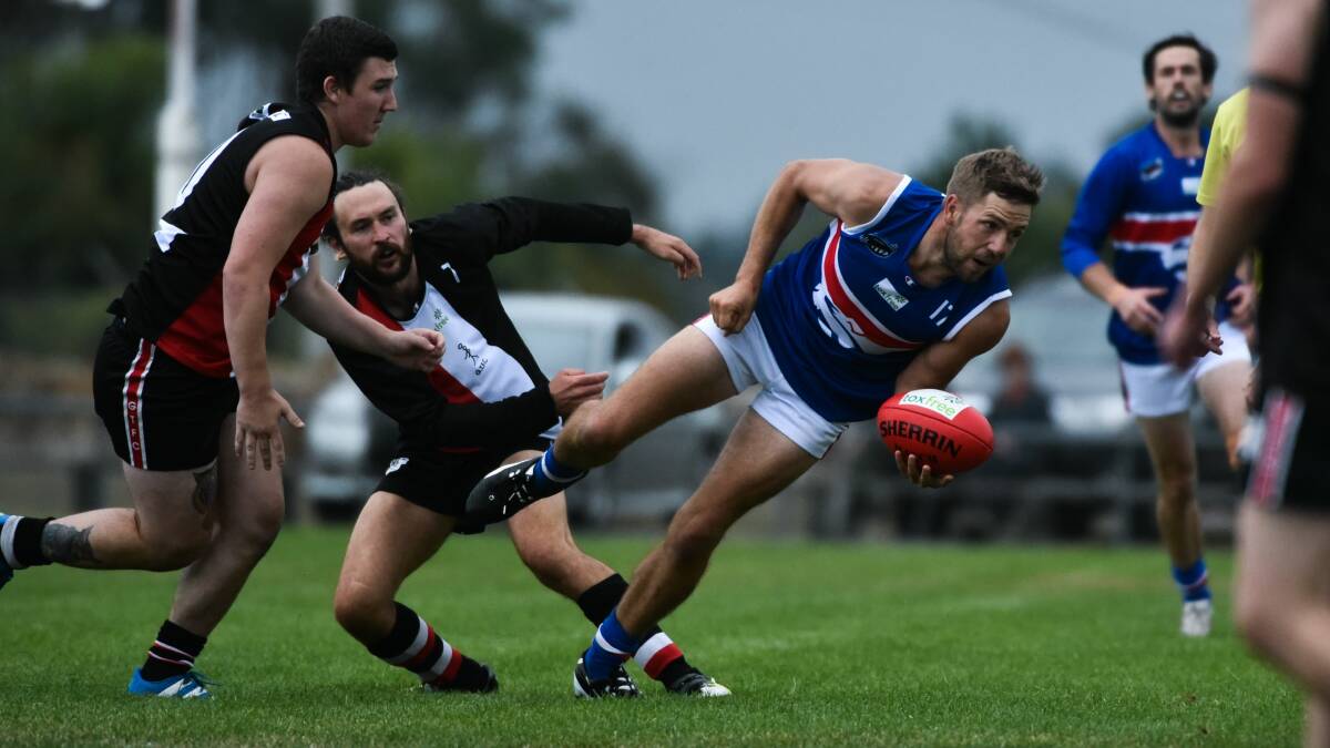 NIMBLE: South Launceston recruit Will Campbell looks to get a handball away under pressure at Blue Gum Park on Saturday. Picture: Neil Richardson