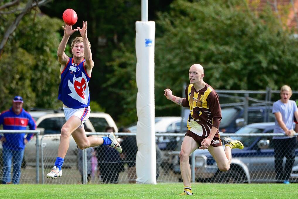 Lilydale forward Billy Tuckerman marks the ball ahead of Prospect utility Will Stoltenberg on Good Friday.	