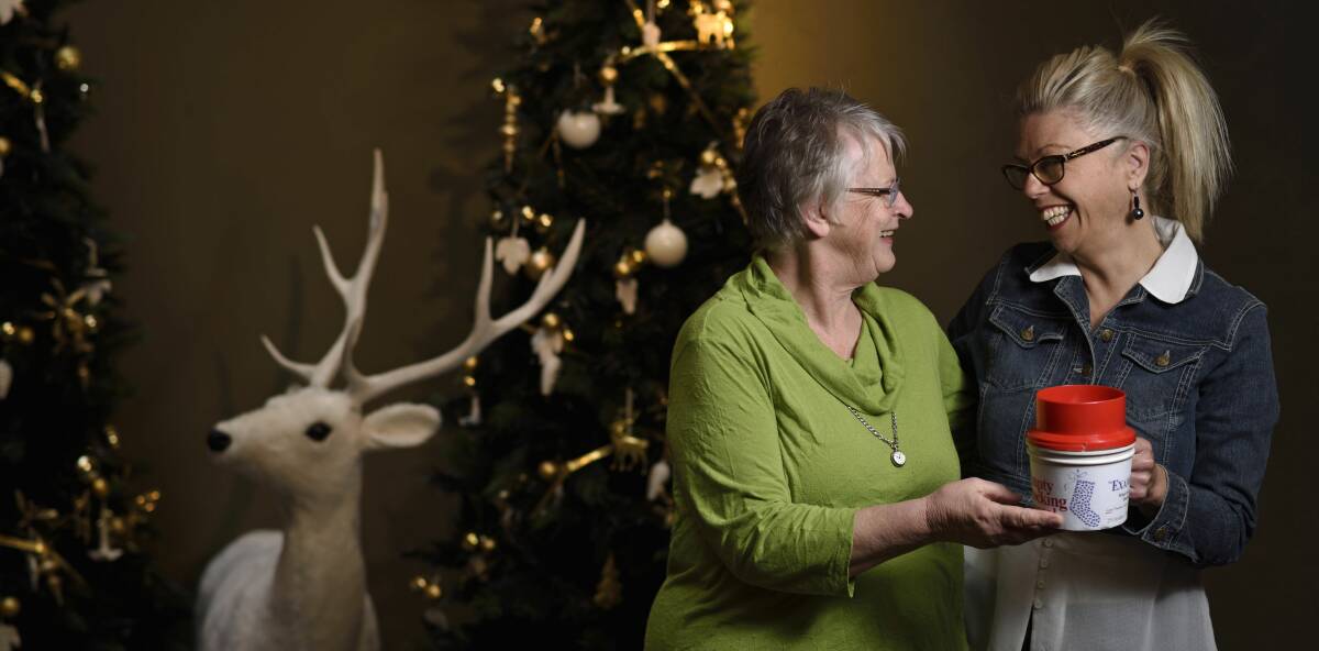 IN NEED: St Vincent de Paul Society's Hetty Binns and The Salvation Army's Alison Best rattle an Empty Stocking Appeal tin. Picture: Scott Gelston