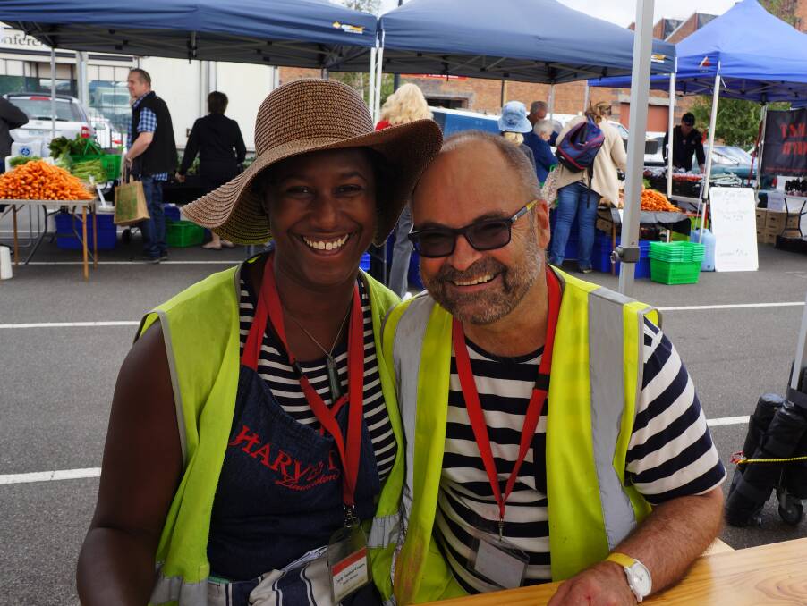 COMMUNITY: Harvest Launceston market manager Curly Haslam-Coates and volunteer George Manifold take a breather after set-up. 