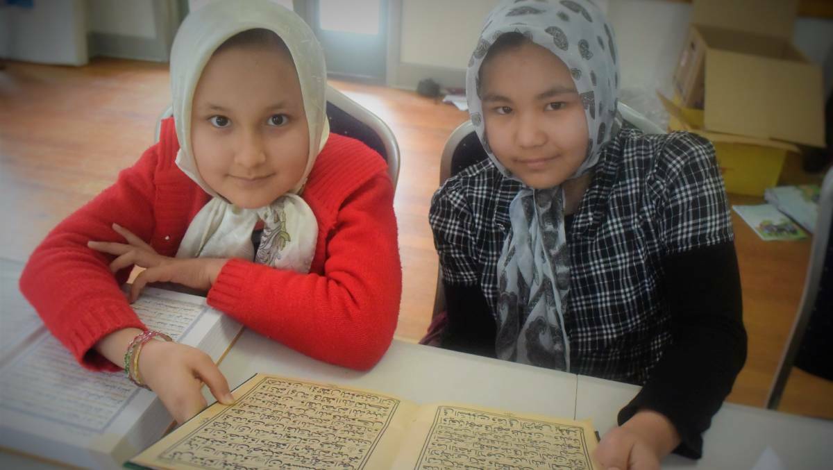 Zeynab Ashrafi and Faezeh Ashouri learning their mother tongue Dari at the community run Afghan Hazara language school to remain connected to their language and culture. Picture: Piia Wirsu