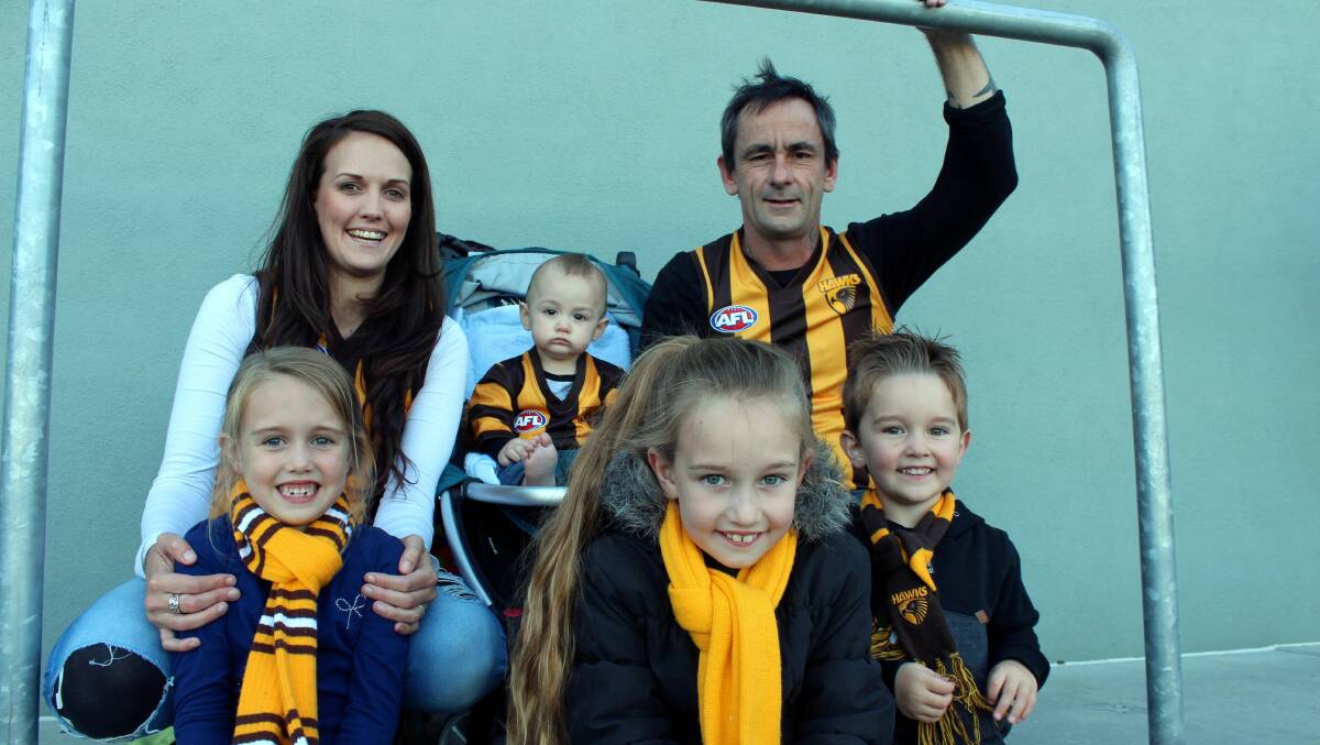 Shilah Lockwood, 6, Hanna Parker, Ace Rigby, 11 months, Tamiya Lockwood, 8, Dale Rigby and Xander Lockwood, 3, got kitted up to attend Hawthorn's training session on Friday. Picture: Hamish Geale
