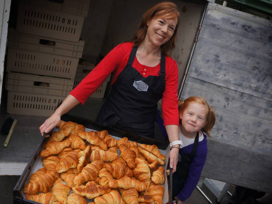 ORIGIN: Glenys Holt and Bridgett Waites, 6, unload croissants at Sandy's Sourdough stall. Pictures: Zona Black
