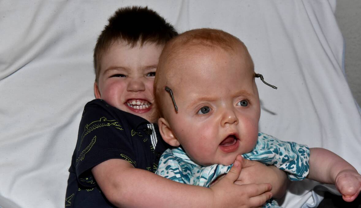 HE AIN'T HEAVY: Curtis Staak, 2, gives little brother Deacon a cuddle. Pictures: Neil Richardson