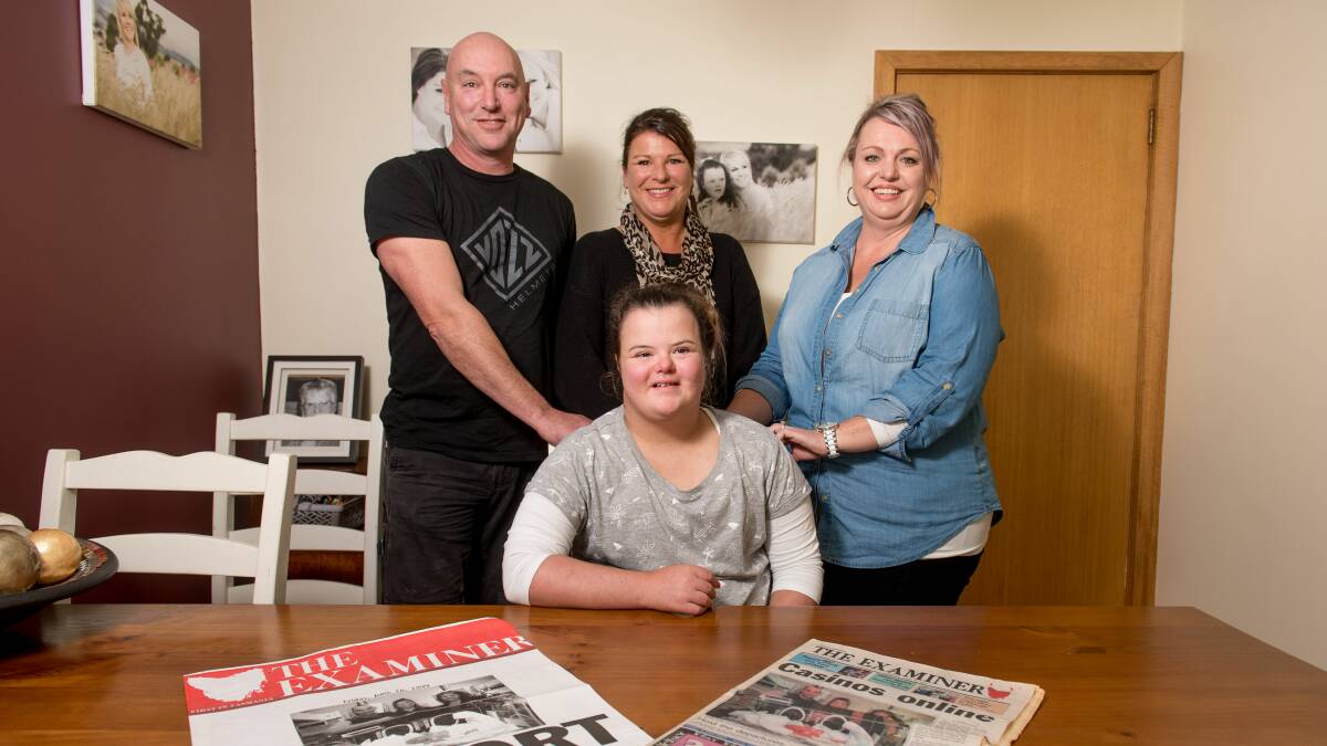 Dad Dean Withers, mum Vicki Young and 'midwife' Dearne Howe gather around Colby Withers as she celebrates her 18th birthday. Picture: Scott Gelston.
