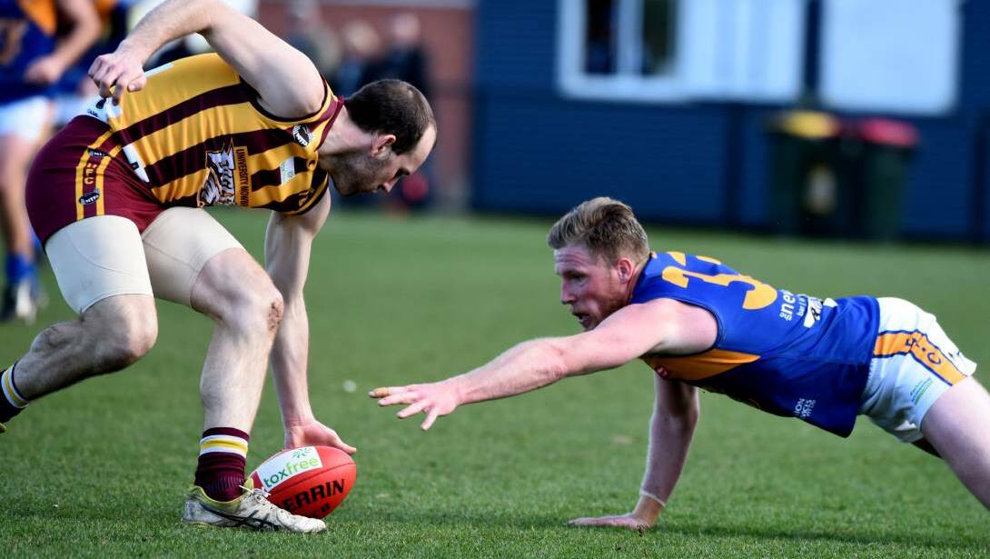Evandale's Clinton Ball scrambles to gain possession from Uni-Mowbray's Matthew Murfett at Invermay Park. Picture: Neil Richardson
