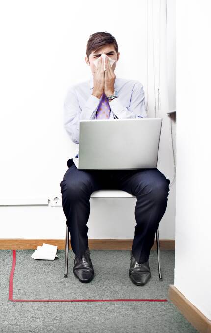 ACHOO: The flu works its magic on an isolated office worker. Picture: iStock.