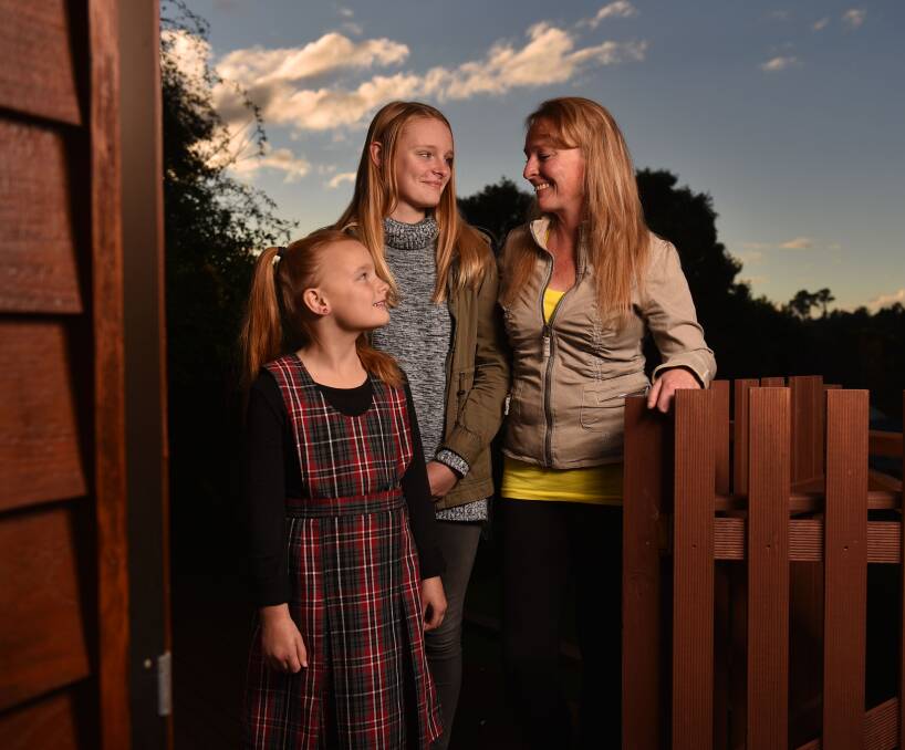 PLENTY TO SMILE ABOUT: Shayla, seven, and Bella, 14, with mum Donna McClymont. Picture: Scott Gelston.