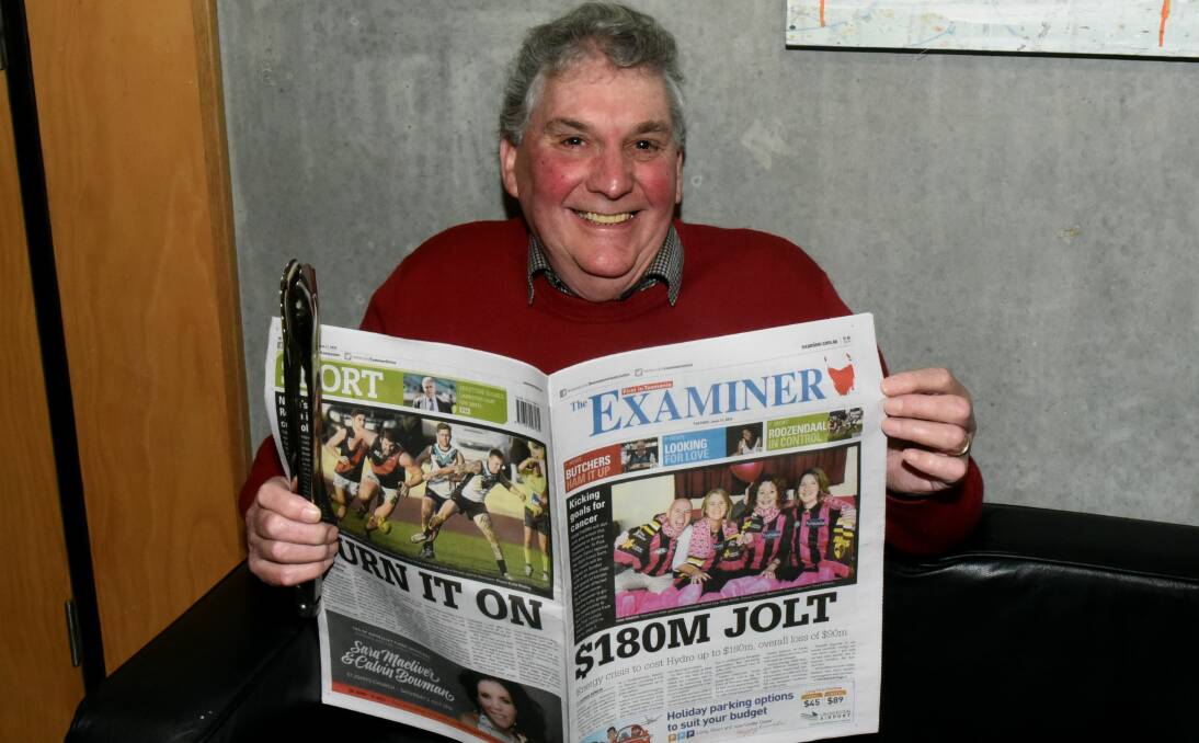 READY STEADY COOK: Deloraine Newsagency owner Mick McHarg with his copy of The Examiner and tongs at the ready. Picture: Neil Richardson.
