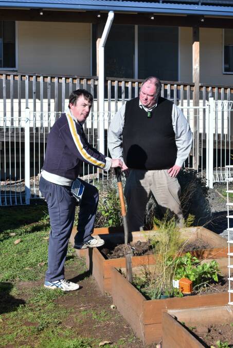 Giant Steps principal Tim Chugg with Chris, 27, in the garden.
