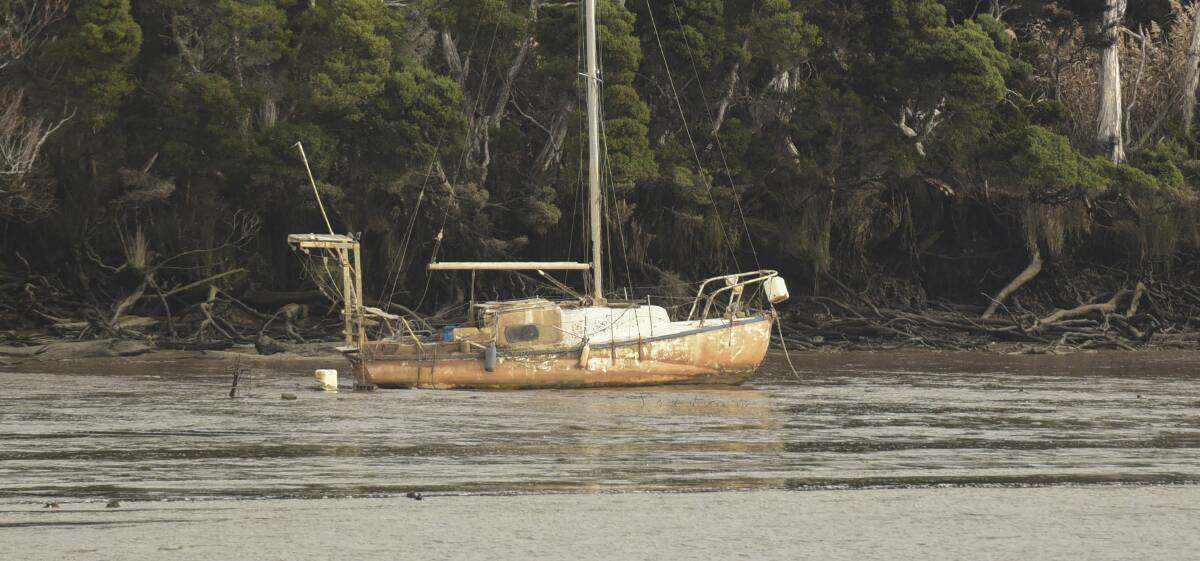 MUDDY: A yacht has been stuck in the mud of the Tamar River since September. Picture: Paul Scambler 