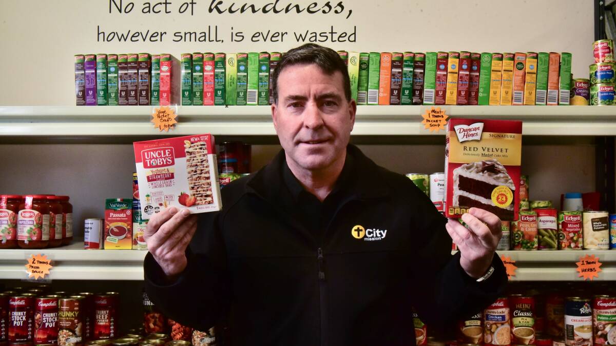 ITEM: City Mission chief executive Stephen Brown with some of the non-perishable products the service is seeking. Picture: Neil Richardson 