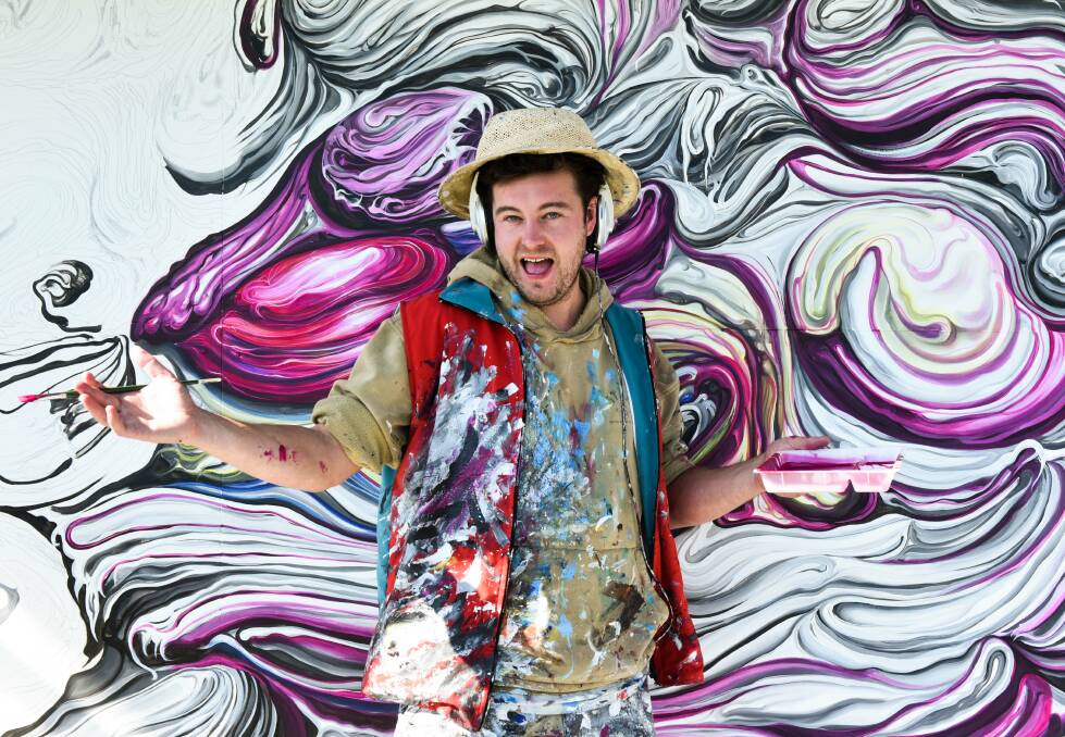 Artist at work: Josh Foley working on his latest artwork at Muralfest at Sheffield. Picture: Neil Richardson