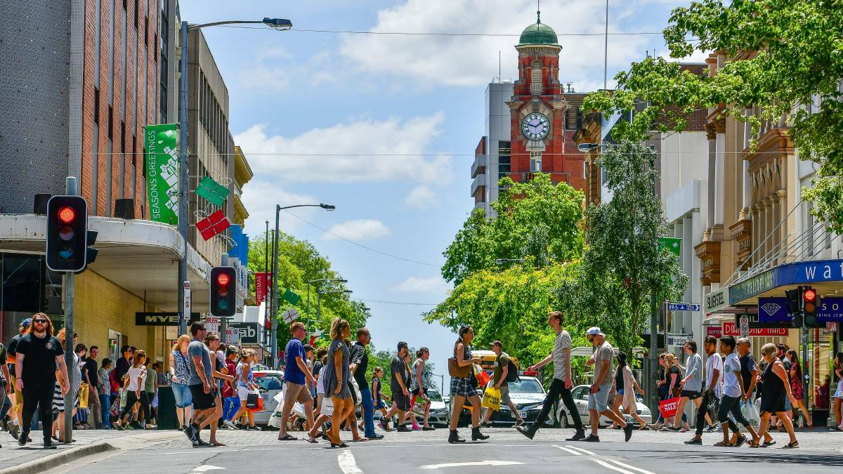 Pedestrians walk cross the intersection of St John and Brisbane streets in Launceston .