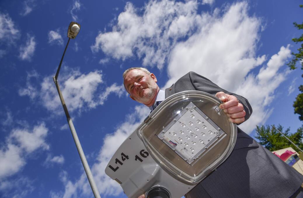 Launceston mayor Albert Van Zetten holds one of the LED street lights when the replacement program was announced earlier in the year. Picture: Paul Scambler