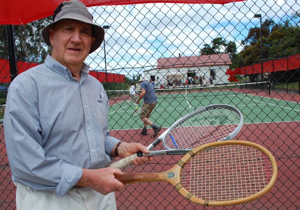 Gus Green with his mother's 1927 Alexander tennis racquet and a modern model.