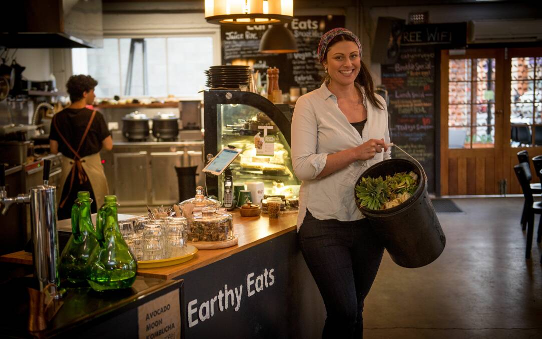 Earthy Eats owner Laura Danderian has been improving the cafe's waste management and is ready to send a bucket of food scraps to compost. Picture: Scott Gelston