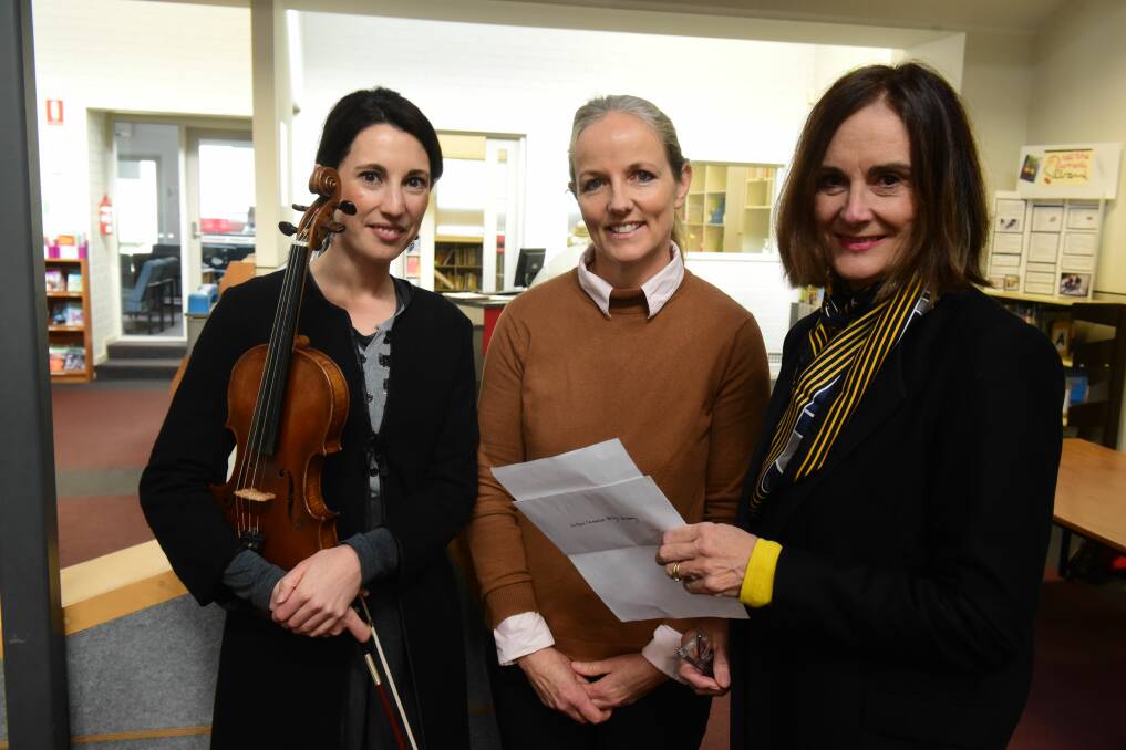 MODEL VIOLINS: Alexandra Harris and Clare Corban-Banks of the Northern Tasmanian String Academy with Lesley Reed of Australian Decorative and Fine Arts Societies Launceston, which gave them a young arts grant for their String on the Move Primary School Program. Picture: Paul Scambler