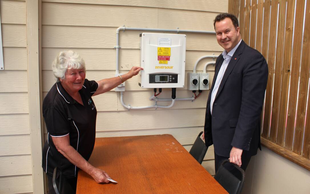 SUNNY DAYS: Former club president and current committee member Robyn Hatton and Tasmanian Liberal Senator David Bushby check the new solar box installed this month. Picture: Supplied