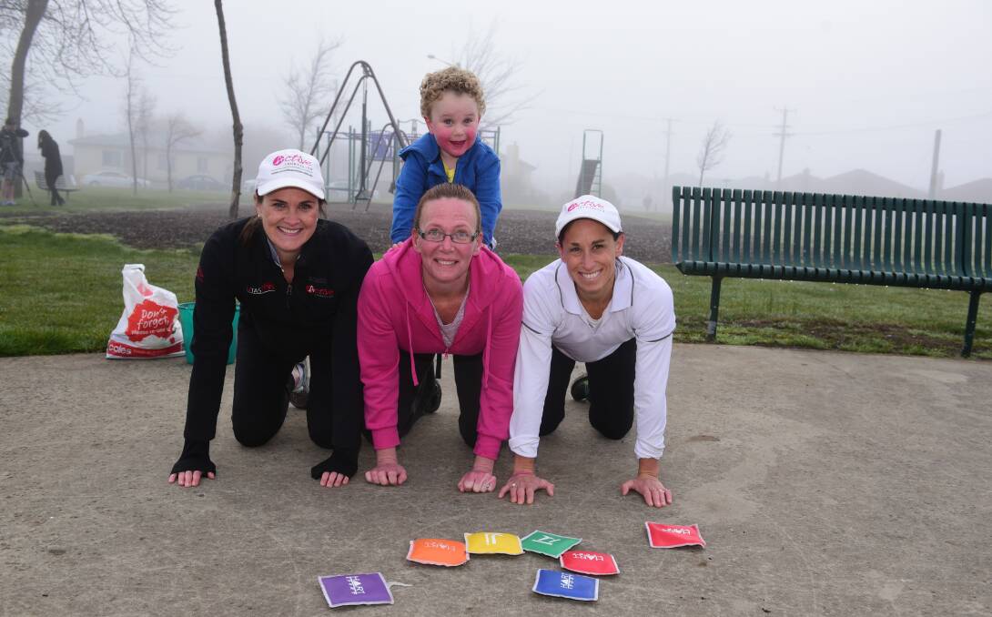 FUN RUN: Active Tasmania 's Lucy Byrne  and Melinda Cannell, of Newnham with Active Kids instructor Megan Culhane and on top is Frankie Cannell, three, who enjoyed running around on a foggy morning. Picture: Paul Scambler