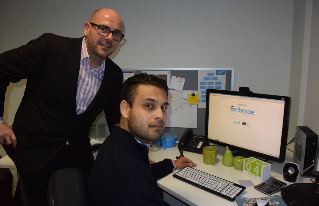 EMBRACE ABILITIES: StGiles service delivery director Mark Deverell and inclusion co-ordinator Ramnik Walia work on the e-learning program Embrace. Picture: Tess Brunton