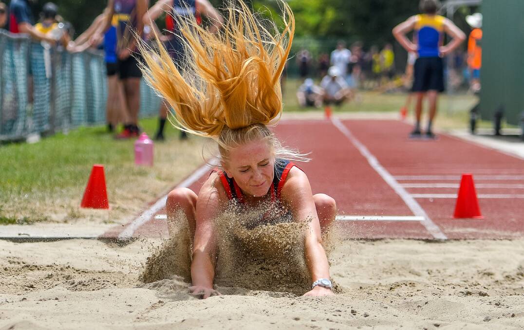 HAIR-RAISING: Queechy High's Jessica Upton-Greer feels the impact of the sand during the grade 10 girls' long jump at the Northern High School Sports Association Division 1 athletics meet on Friday. Pictures: Scott Gelston.