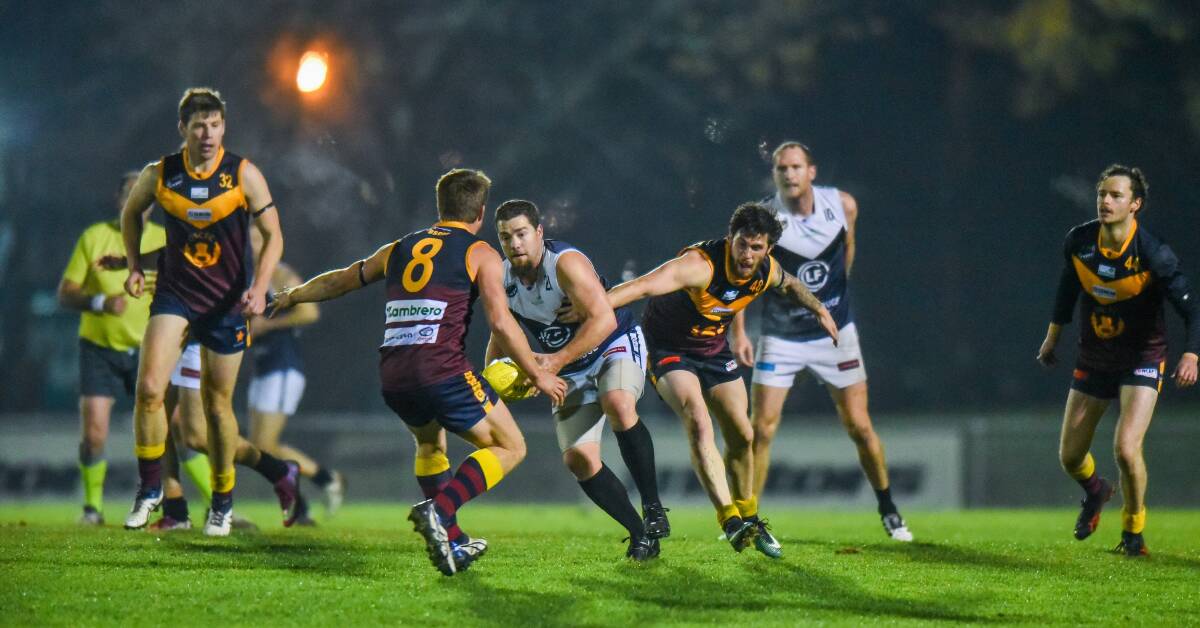 TRAPPED: Old Scotch had the better of the numbers around ground level in a night out against Old Launcestonians under the lights of the NTCA Ground. Picture: Scott Gelston