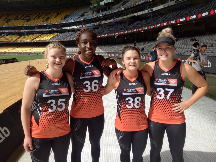 OUT TO REPRESENT: Tasmanian female footballers Daria Bannister, Loveth Ochayi, Courtney Webb and Georgia Hill gather for a breather between the AFLW draft combine testing on Wednesday at Etihad Stadium. Picture: Supplied 