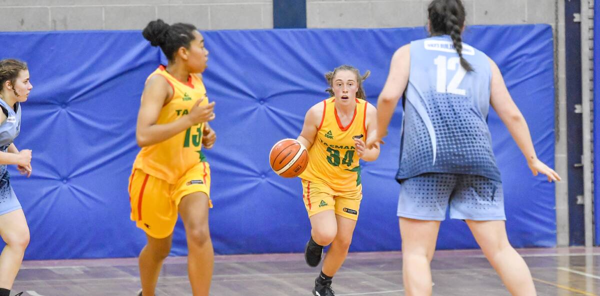 THE DRIVE: Shelby Rayner for BTAS brings the ball back up court against Penguin. The match was one of four Basketball Tasmania men and women's semi-finals.