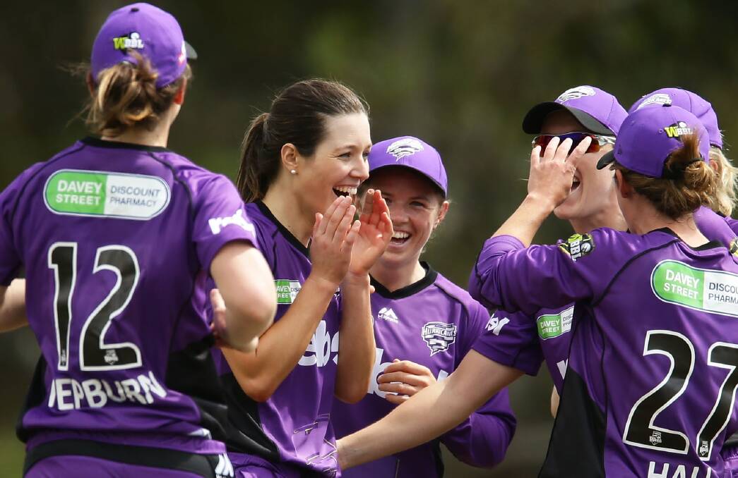 GOTTA HER: Launceston's Brooke Hepburn runs to join Hurricanes players celebrating her hometown teammate Katelyn Fryett in celebrating her first wicket. Picture: Gettys Images 