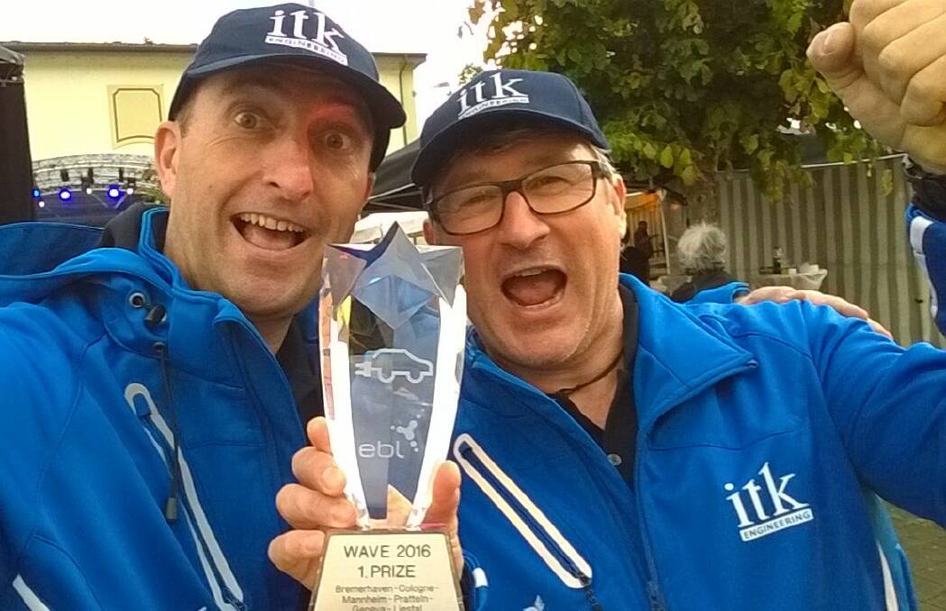 ELECTRIC DREAMS: Engineer Mark von Bibra (left), formerly from Launceston, and teammate Ruediger Hauser celebrate their Wave rally win for the ITK Engineering team.
