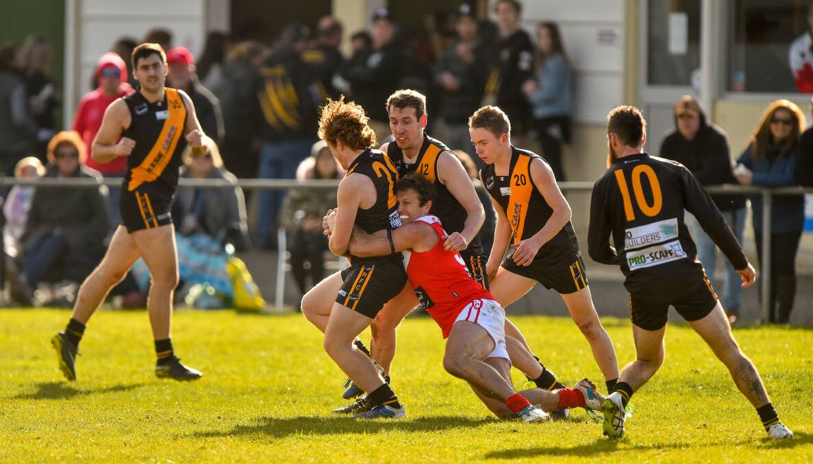 SMASH AND GRAB: Brown lays a hard tackle surrounded by bewildered Tigers.