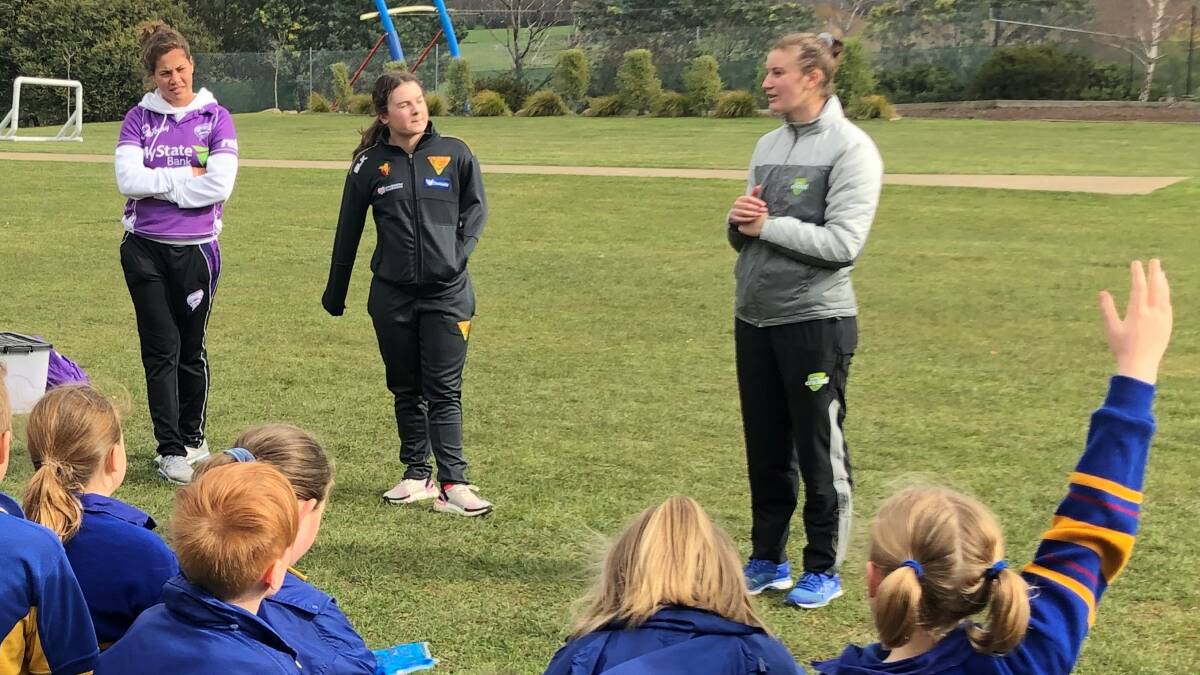 GIVING A HAND: Belinda Vakarewa (left) joins a Cricket Tasmania school clinic that involved former South Launceston star Courtney Webb (centre). Picture: Cricket Tasmania