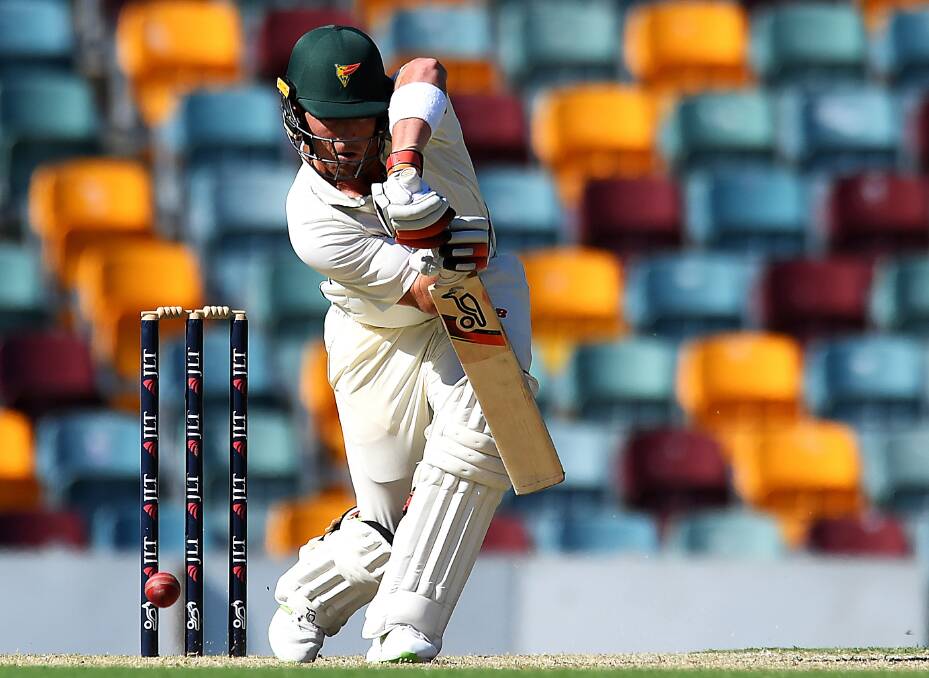 STRAIGHT BAT: Ben McDermott returns to his former state in Tasmanian colours at the Gabba. Picture: AAP