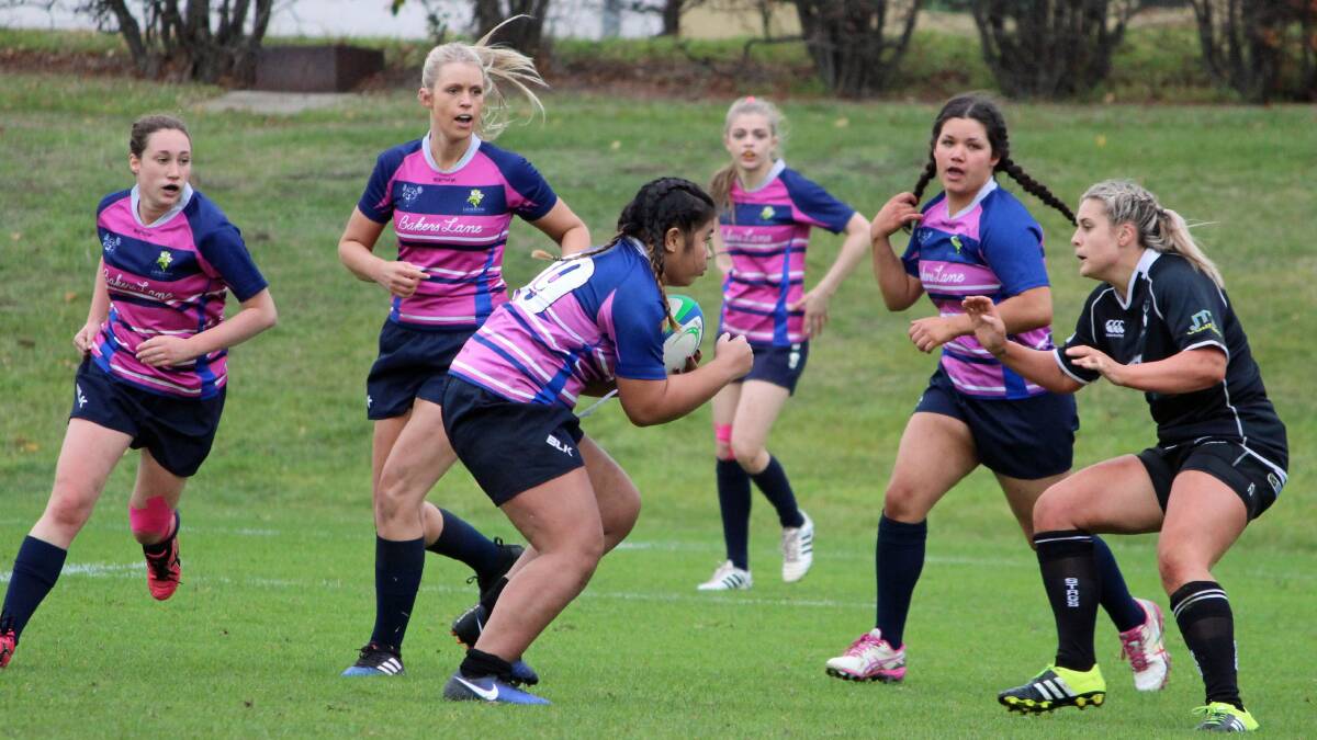 IMPACT: Launceston's Bernadette Tapili prepares to drive up towards the Glenorchy defensive line as Queen Bees teammates watch at the state finals. Picture: Peter Cochrane.