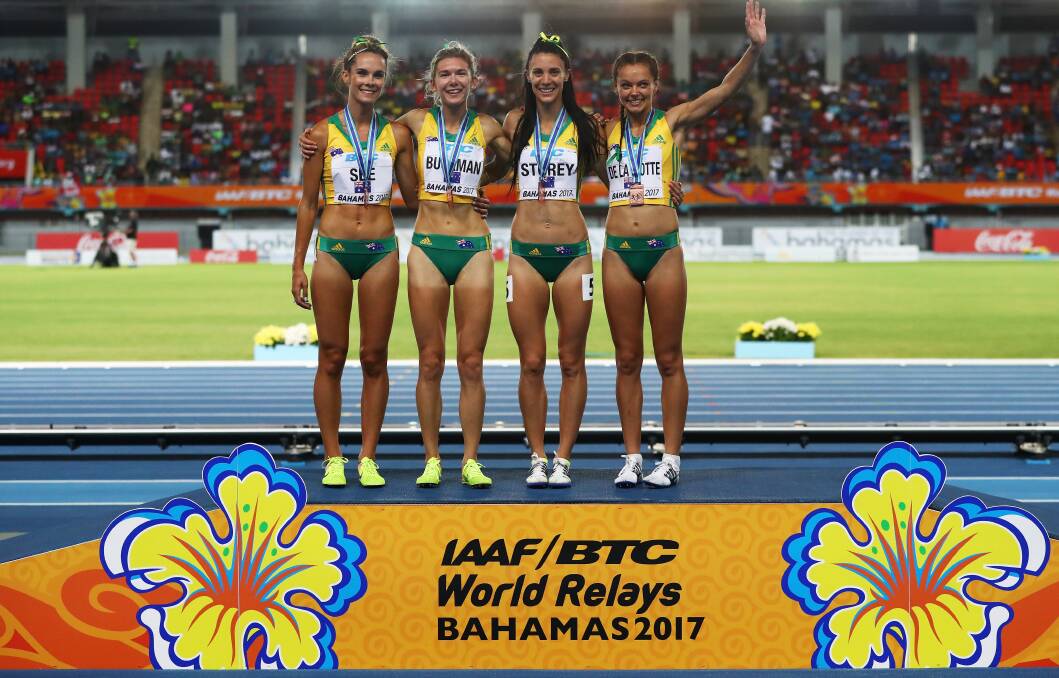 TAKE A BOW: Australians Heidi See, Zoe Buckman, Lora Storey and waving Abbey de la Motte celebrate bronze in the women's 4 x 800 metres relay final in the Bahamas.