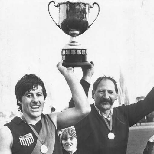HEROES: North Launceston 1983 captain Ricky Young shares a moment with his father and senior coach Tony 'Chang' Young, holding up the then-NTFA premiership trophy at York Park in the Robins 28-point win over Longford. Picture: Examiner archives