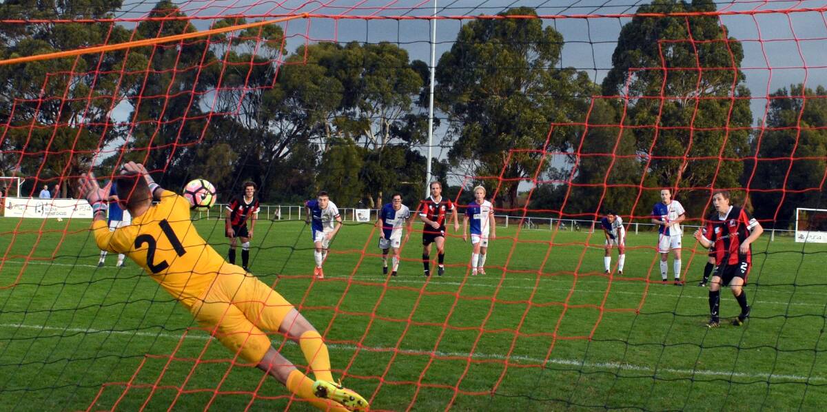 GAMECHANGER: Northern Rangers keeper Sam Whatman saves the Clarence United penalty in Sunday's thrilling NPL finish. Picture: Walter Pless.