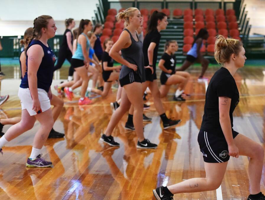 STRETCH IT OUT: The state's AFLW aspirants test their agility in Launceston as part of their athletic testing for the Tasmanian Youth Girls State Academy.