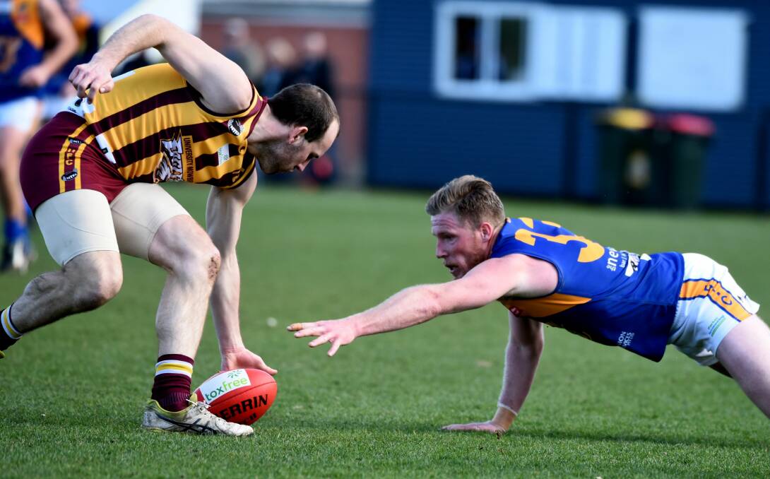OUT OF REACH: Evandale's Clinton Ball scrambles to gain possession from Uni-Mowbray's Matthew Murfett at Invermay Park. Picture: Neil Richardson