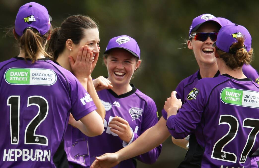 SHOCKED: Launceston's Brooke Hepburn runs in to join Hurricanes players celebrating fellow teammate Katelyn Fryett's first wicket. Picture: Getty Images