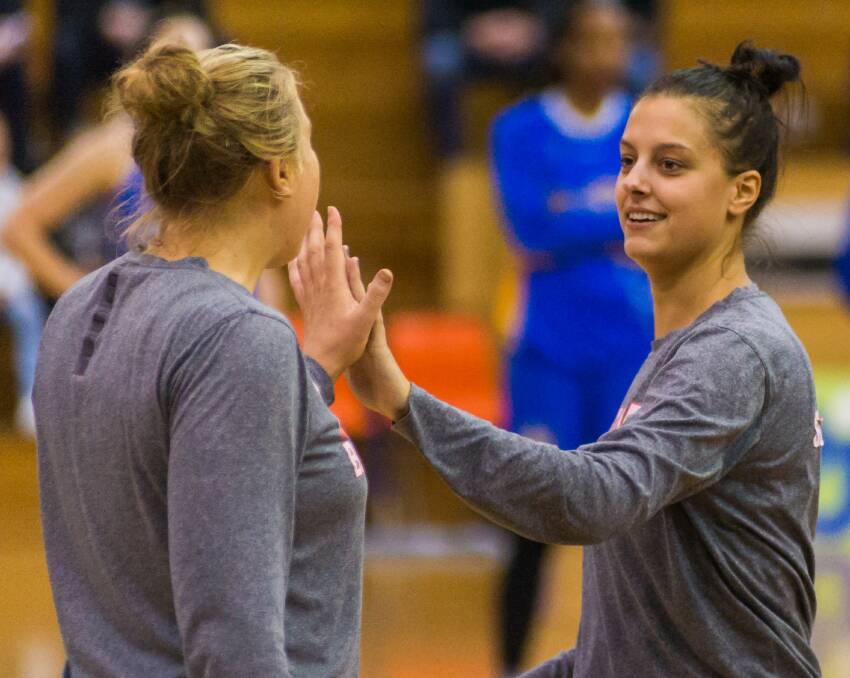 HIGH FIVE: Tornadoes teammates Tayla Roberts and Olivia Chugg combined on Friday night for 30 valuable points. 
