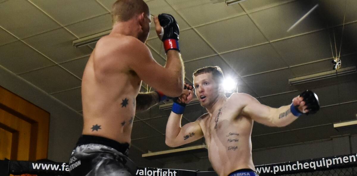 FIGHT ON: Launceston fighter Damon Upton-Greer looks to strike ex-Launceston and now Gold Coast's David Butt during the MMA Valor 15 main event. Picture: Scott Gelston